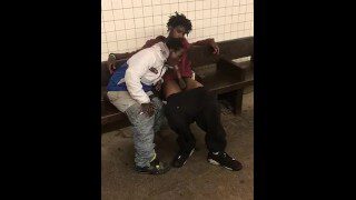 Two homeless black men having oral fun at a subway station